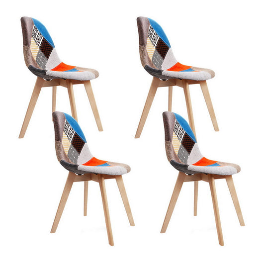 Set of four retro velvet dining chairs with multicolor patchwork upholstery and light wooden legs, perfect for vintage home.