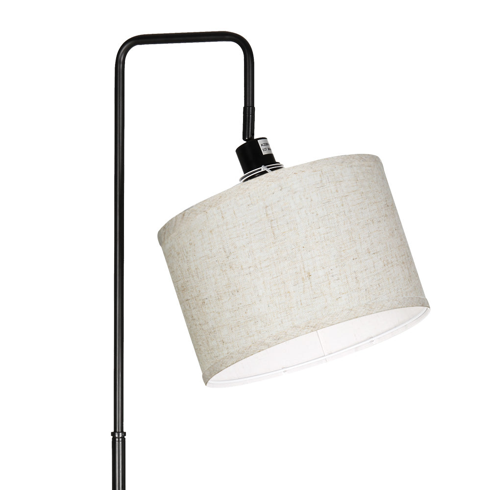 Tall black metal floor lamp with an adjustable arm and angled beige fabric lampshade, showcasing retro vintage style for.
