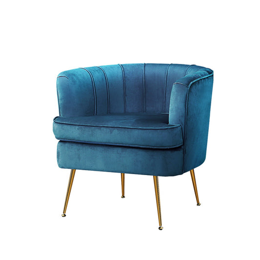 Blue velvet armchair with curved retro design and channel tufting, supported by slender gold metal legs, perfect for.