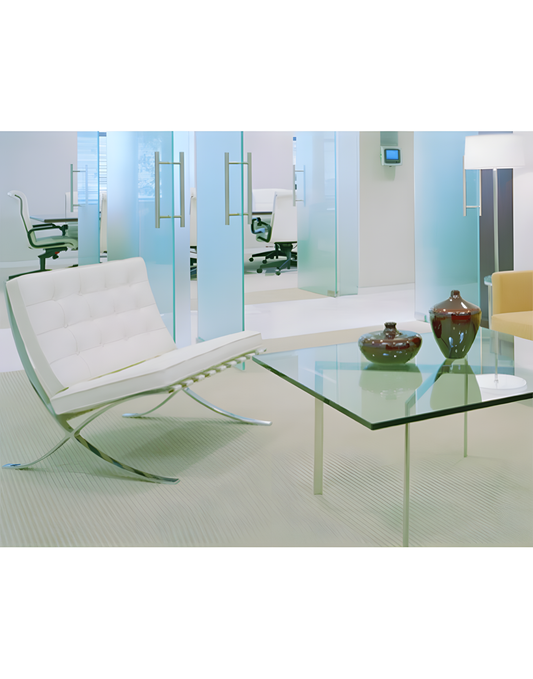 White leather Barcelona chair with polished chrome frame near glass coffee table, set in modern office space with frosted.