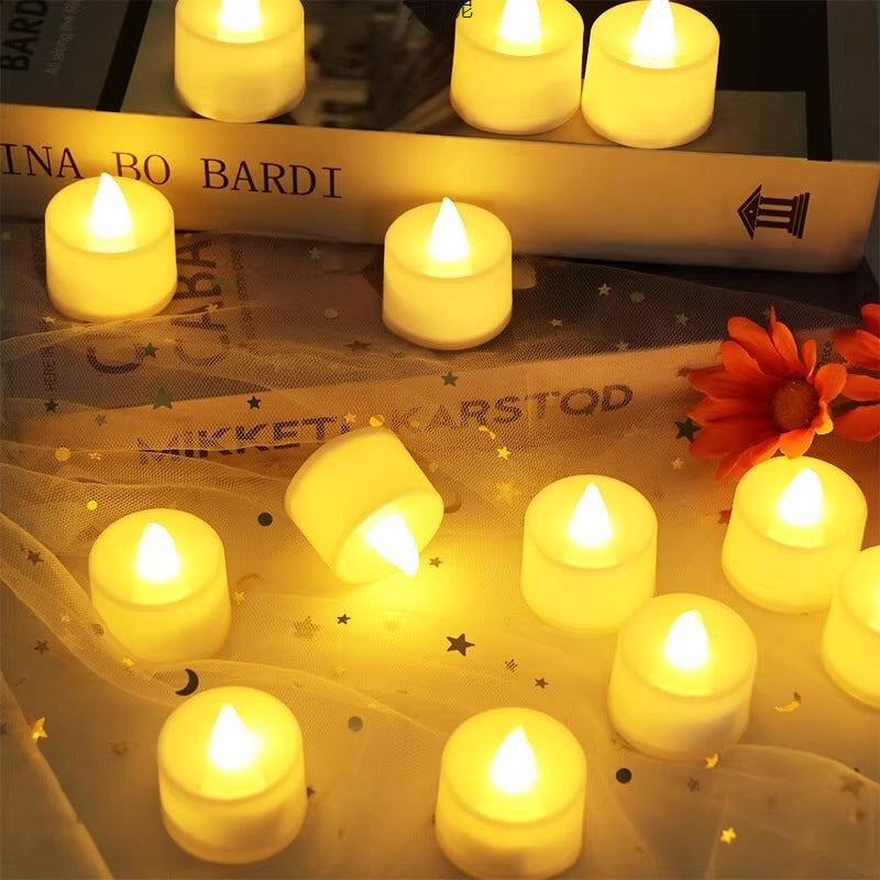 Set of 24 velvet-covered heart-shaped LED tea lights glowing warmly on a vintage fabric with star patterns, styled with.