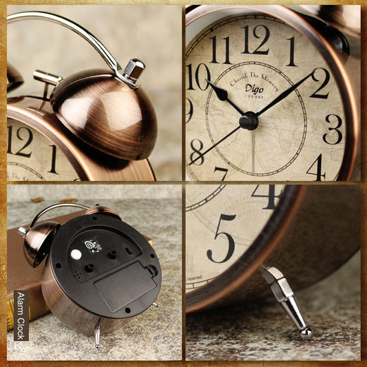 Vintage bronze twin bell alarm clock with cream dial and black numbers on wooden surface, retro Velvet finish with metal.
