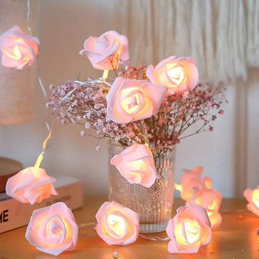 Soft pink velvet 3D rose fairy lights glowing gently around vintage glass vase with dried flowers, cozy retro home decor.