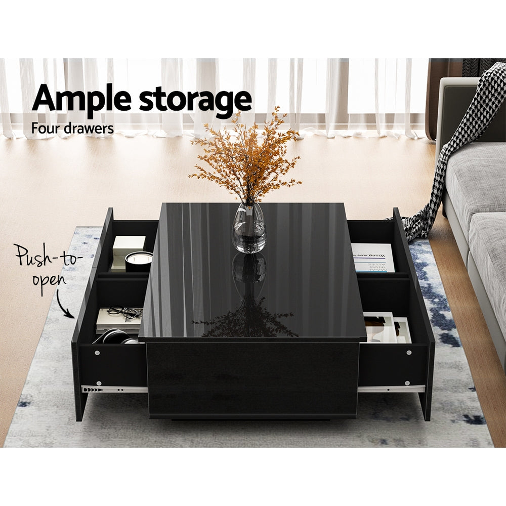 Black Artiss coffee table with four velvet-lined drawers open, showcasing ample storage in a bright living room with natural .