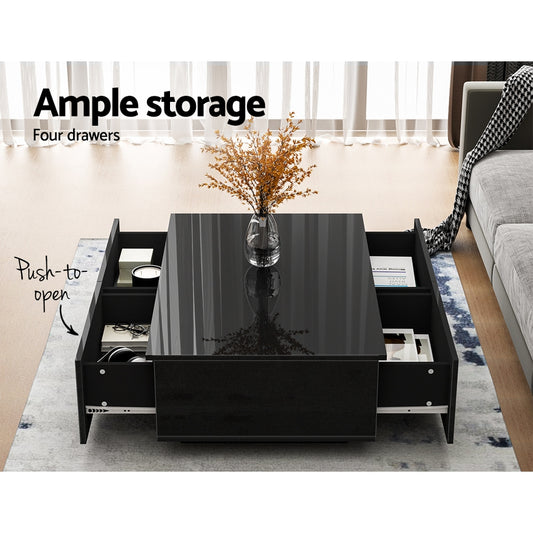 Black Artiss coffee table with four velvet-lined drawers open, showcasing ample storage in a bright living room with natural .