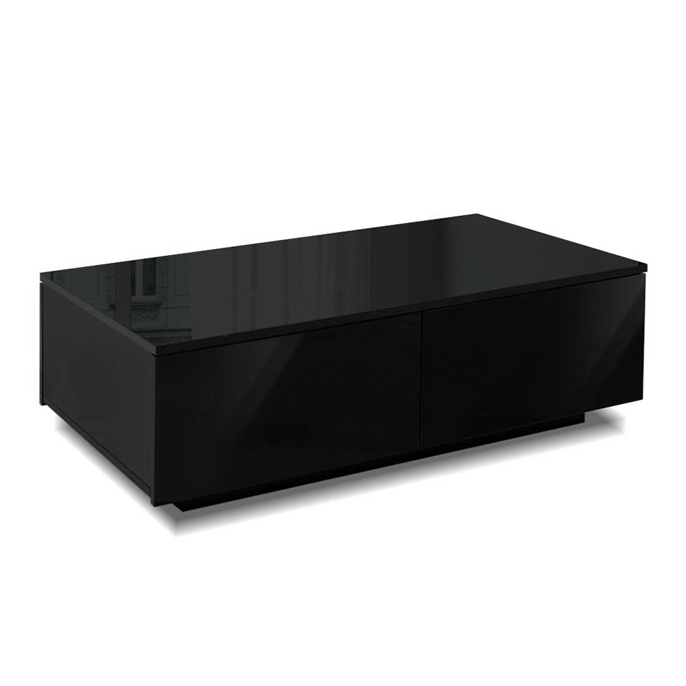 Black rectangular coffee table with four smooth-front drawers, glossy finish, sleek vintage design, minimalist retro style.