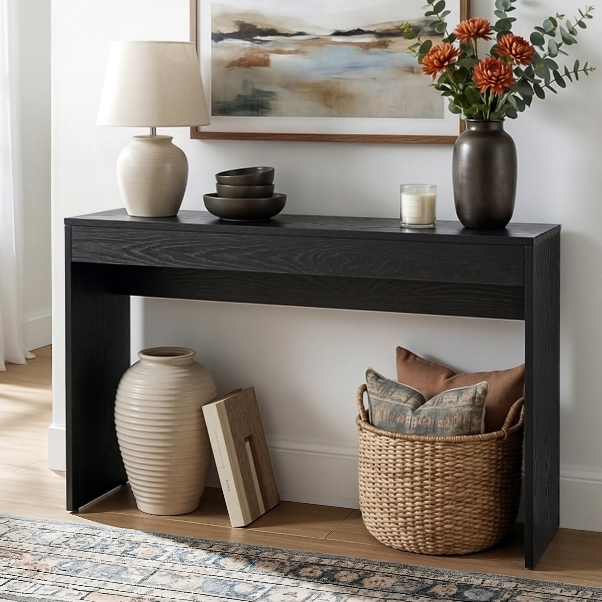 Black console table with decorative items in a room setting