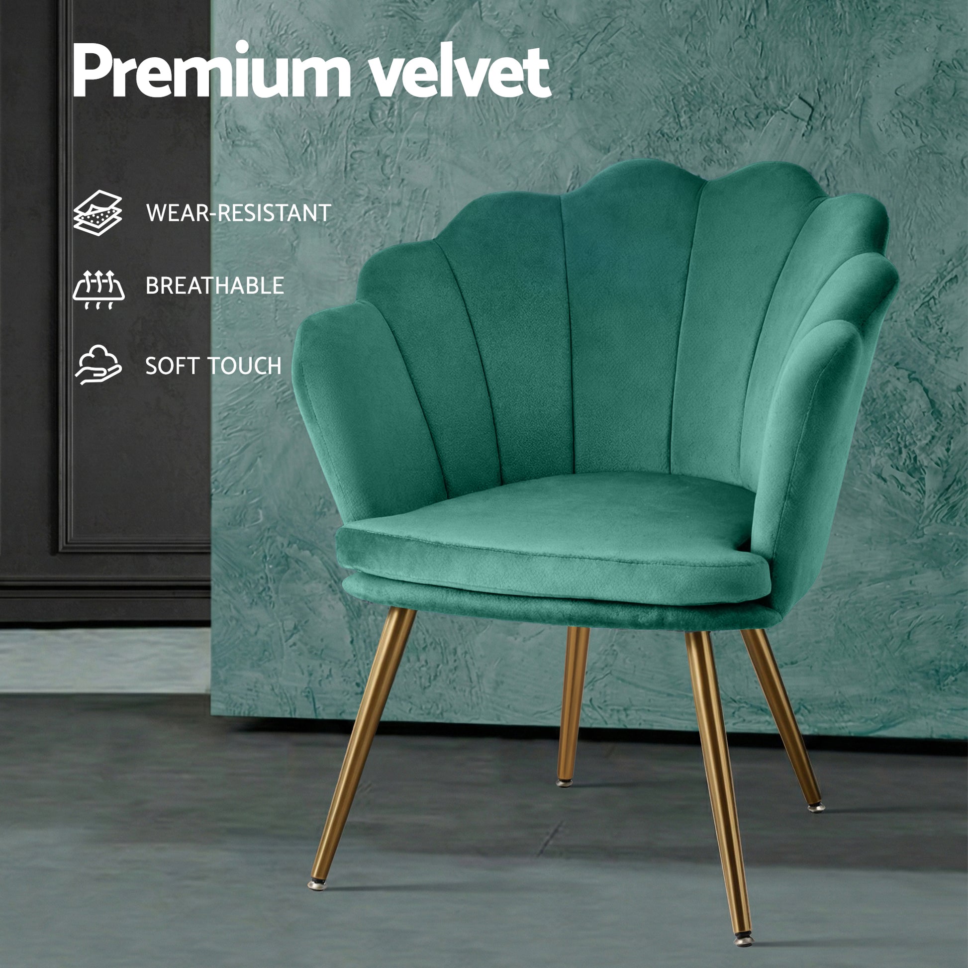 Green velvet retro armchair with scalloped shell-back design and gold tapered legs, set against grey and teal textured walls .