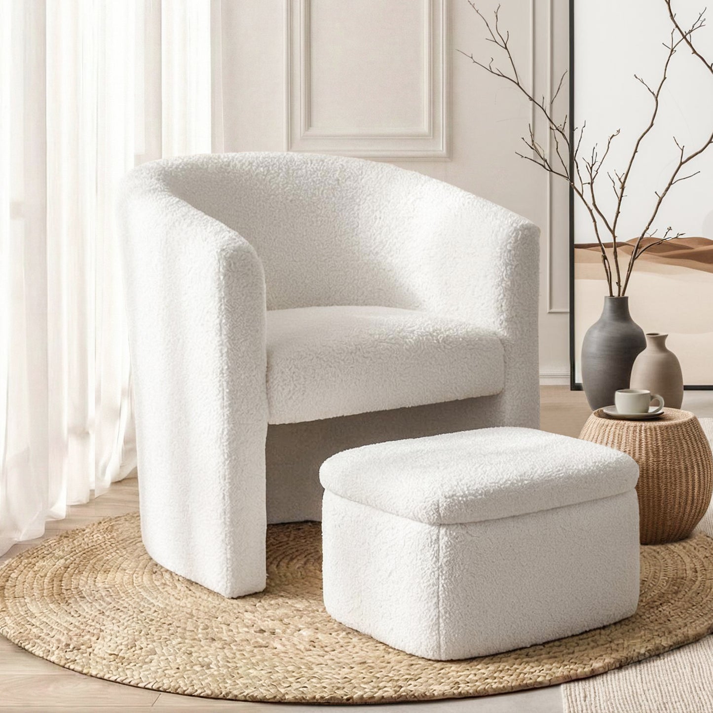 White boucle armchair with curved back and rounded arms, paired with matching square ottoman on woven jute rug in bright.