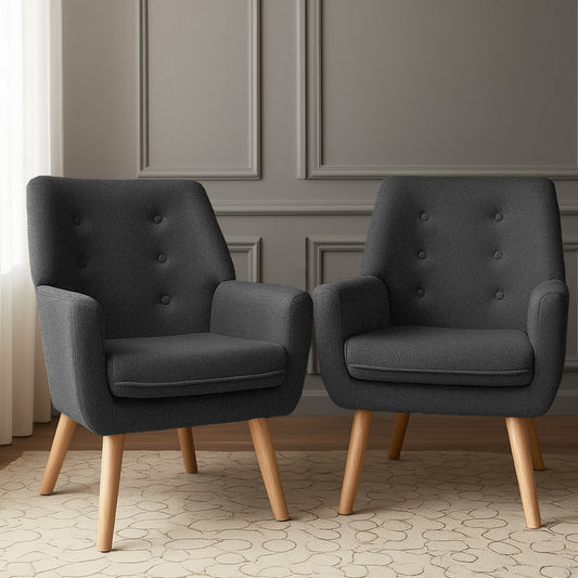 Pair of charcoal velvet armchairs with retro button tufting and wooden legs in elegant vintage-style living room with.
