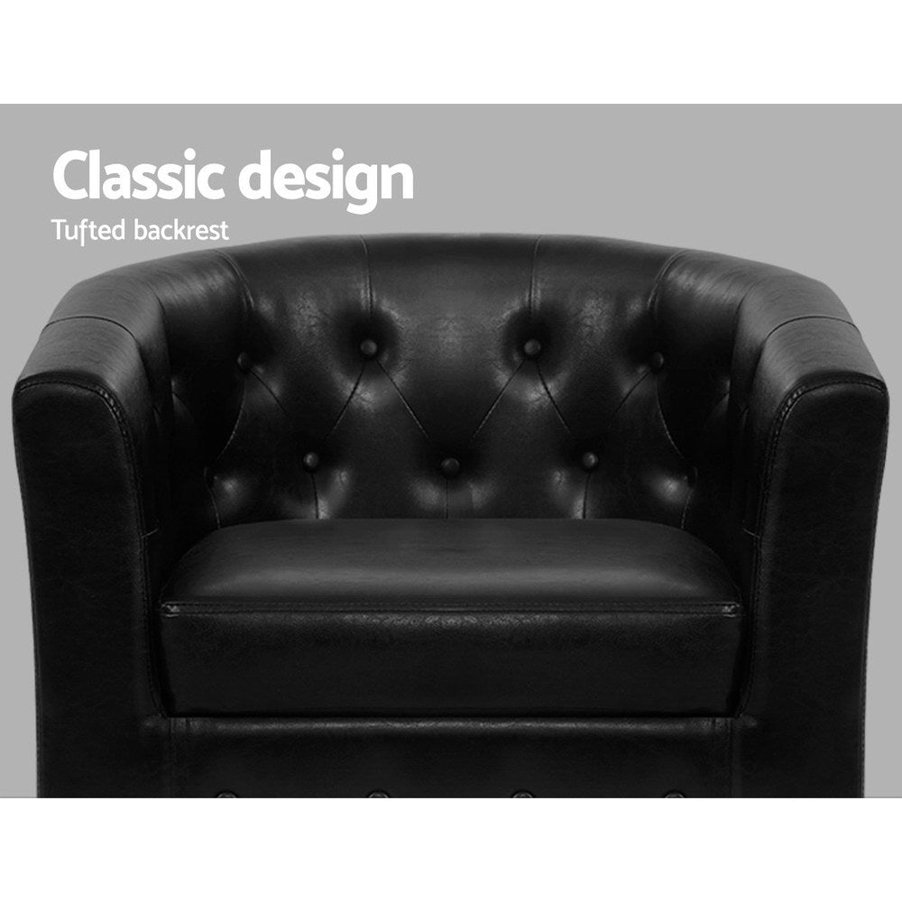 Black leather armchair with tufted backrest on a gray background