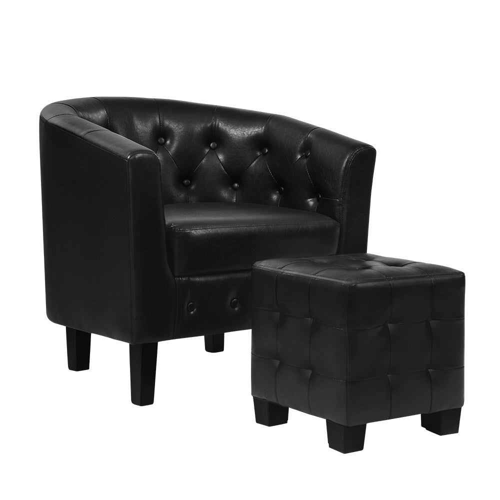 Black tufted armchair with matching ottoman on a white background