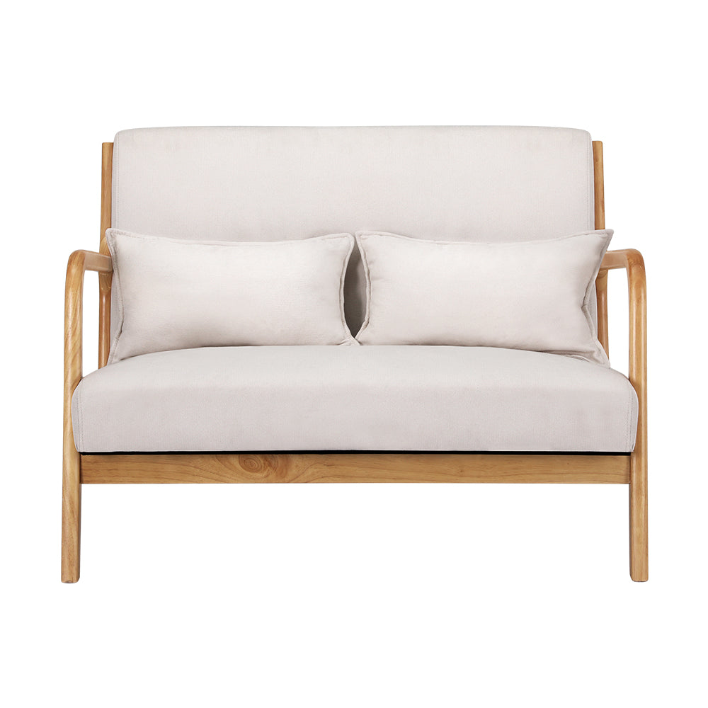 Beige velvet two-seater armchair with light wood frame and matching rectangular cushions, retro vintage style for home decor.