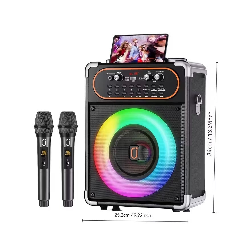 Black wireless karaoke machine with glowing rainbow LED speaker, two black microphones, and tablet displaying a party scene, .