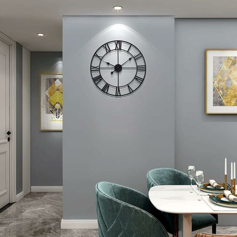 Dining room with a large wall clock, table setting, and framed artwork on gray walls.