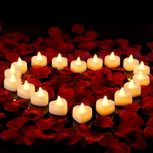 Heart-shaped arrangement of warm LED tea lights on deep red velvet rose petals, creating a vintage, romantic home decor vibe .