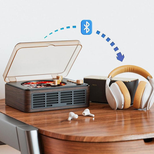 Record player, headphones, and earbuds on a wooden surface with Bluetooth connectivity symbol.