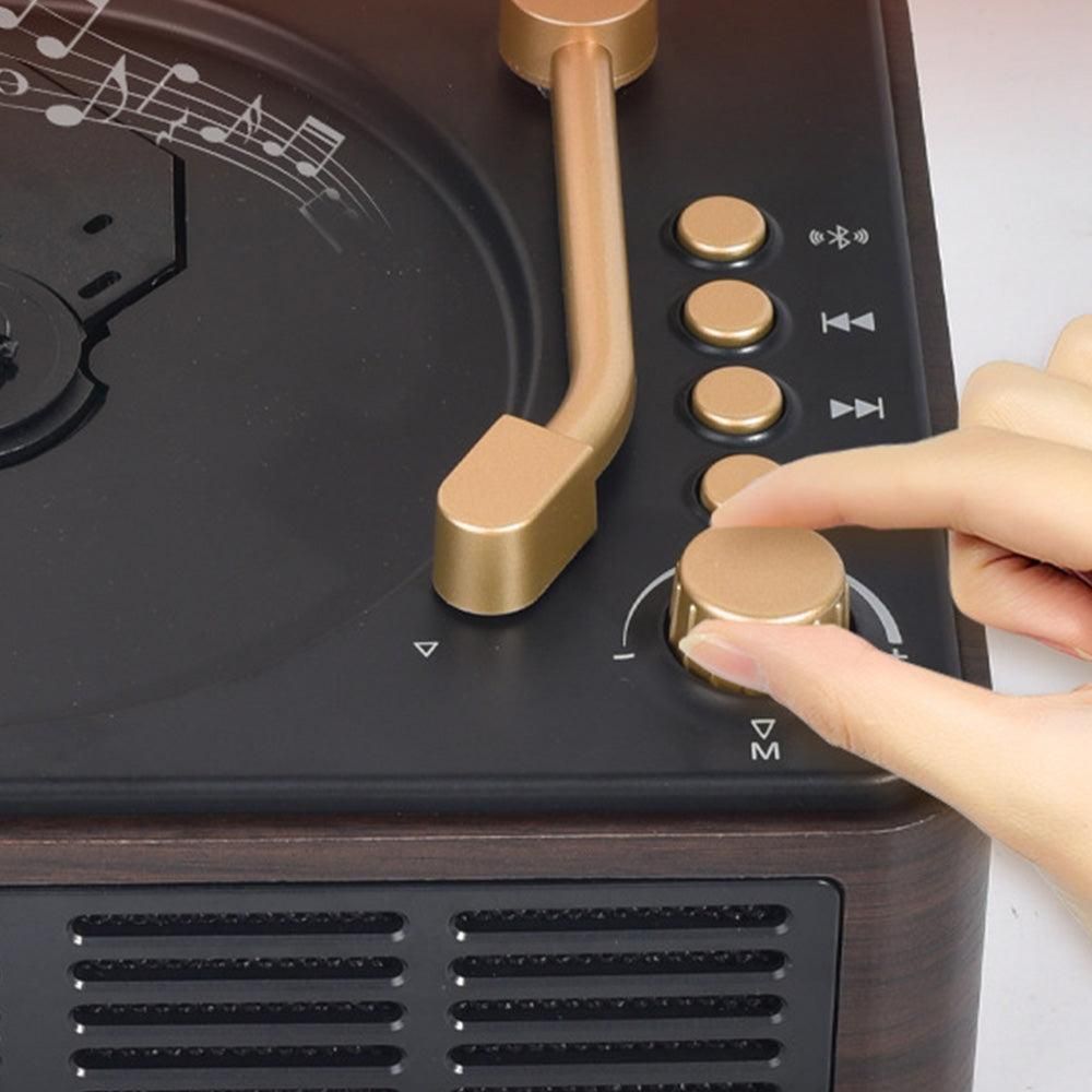 Close-up of a person adjusting knobs on a vintage-style record player.