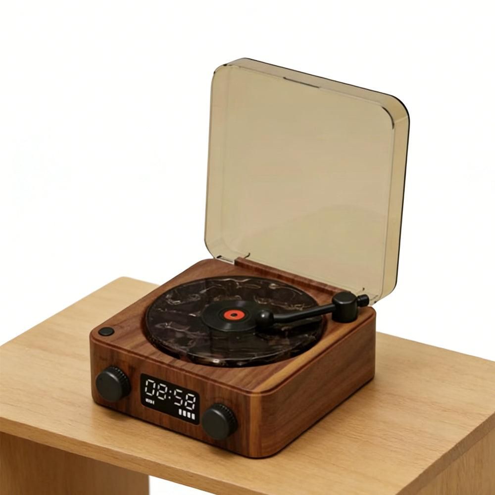 Wooden record player with a clear dust cover on a wooden surface