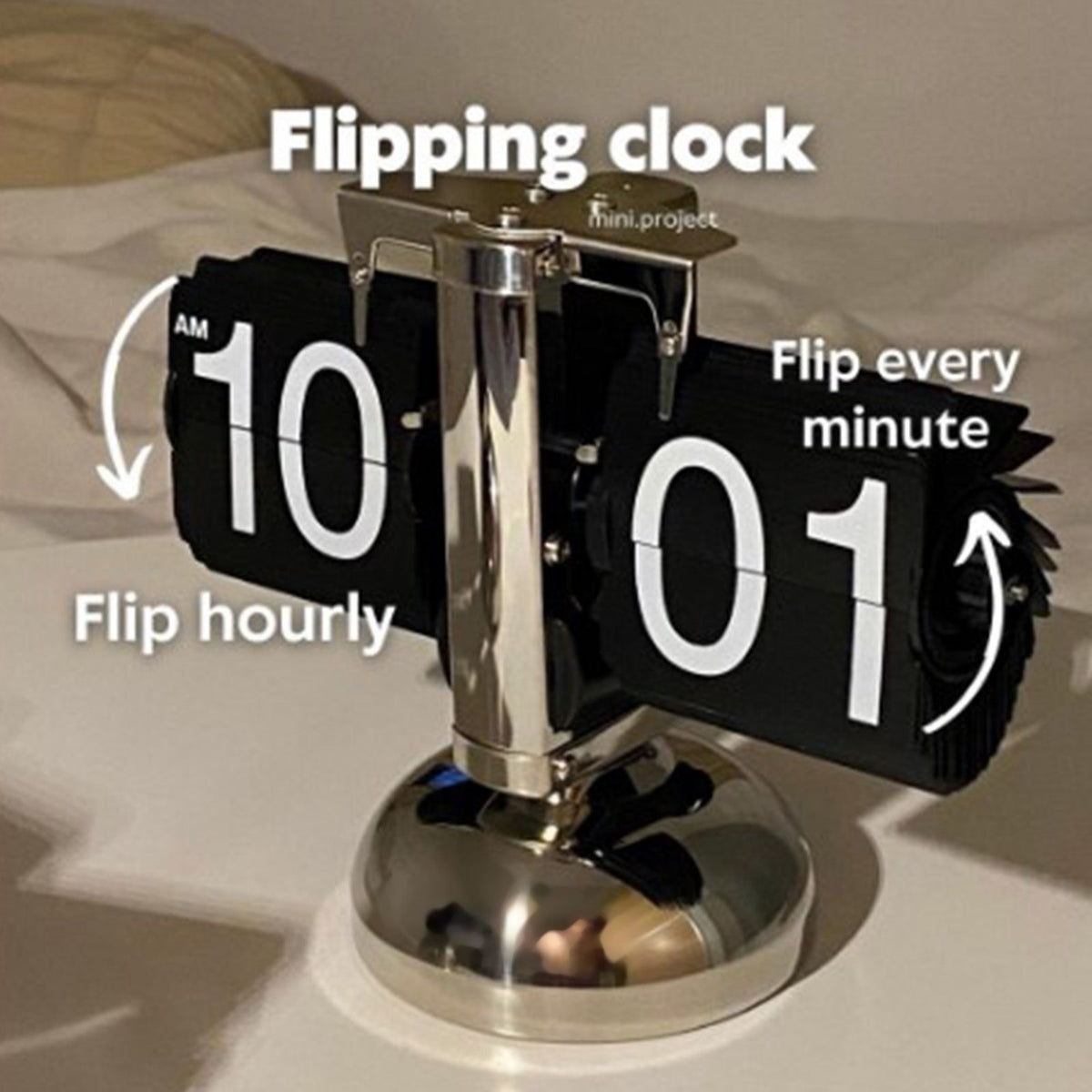 Flipping clock with AM/PM display on a neutral background