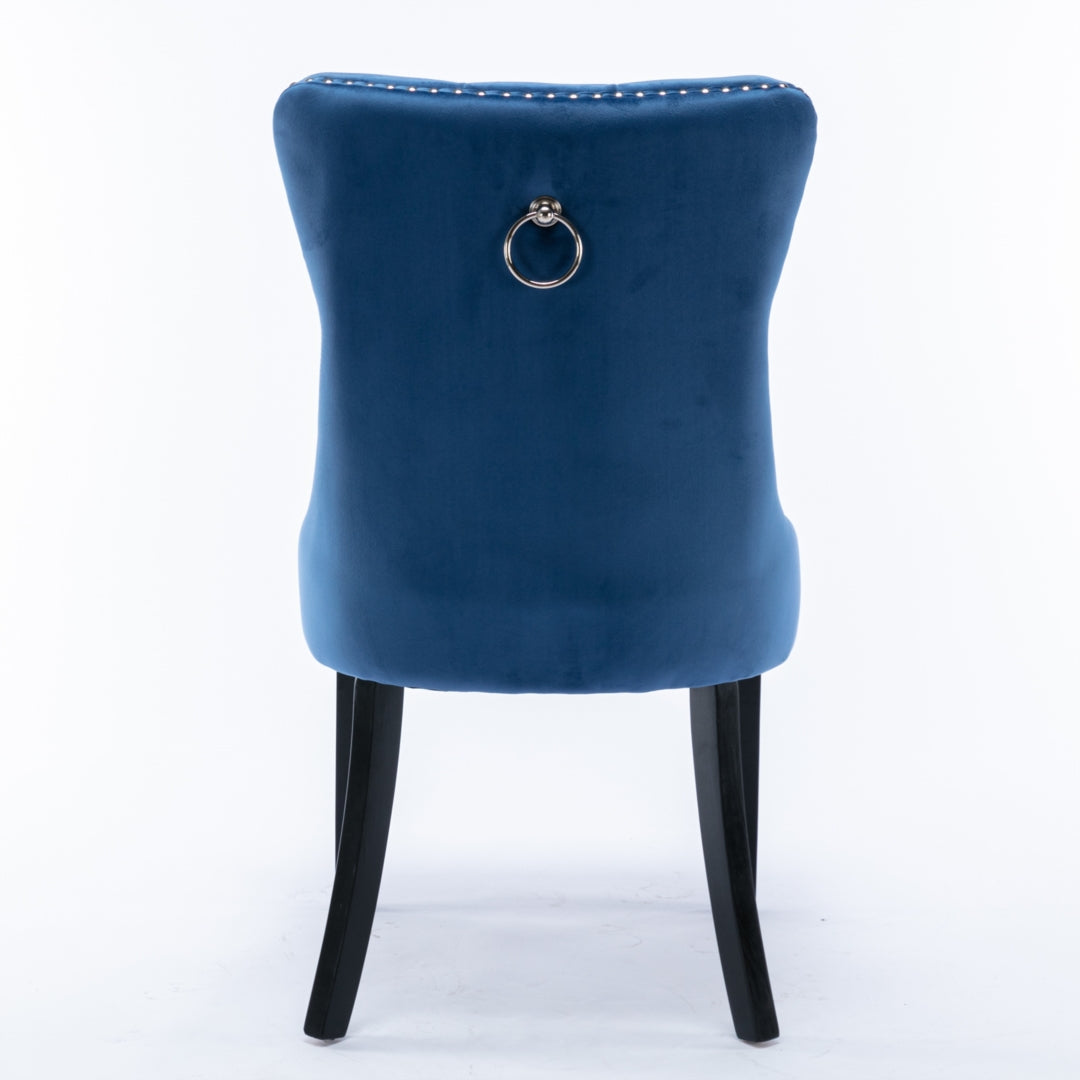 Blue velvet wingback dining chair with silver stud trim, brass ring pull, and dark solid wood legs, retro vintage style from .