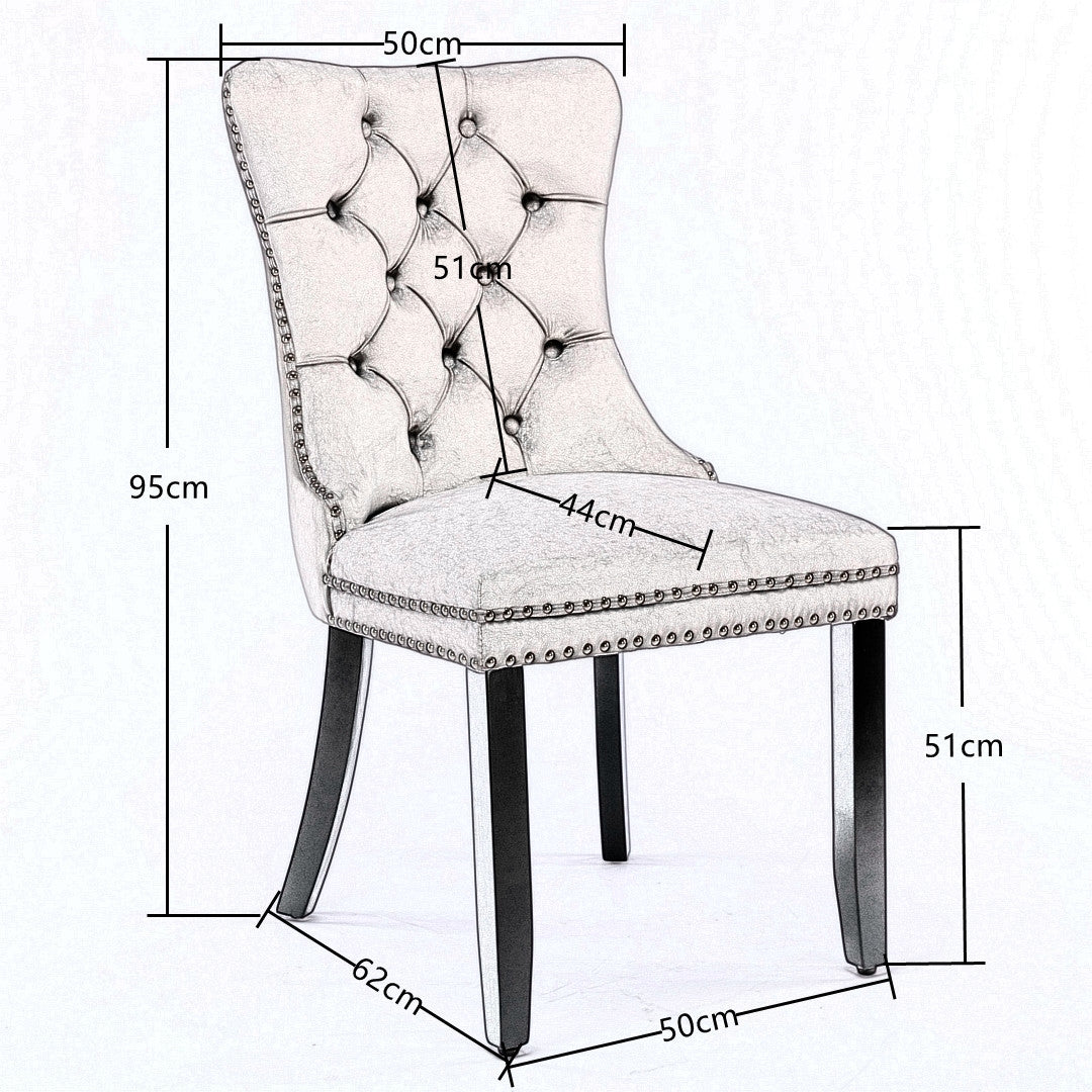 Vintage-style blue velvet wingback dining chair with deep button tufting, silver stud trim, and dark solid wood legs, shown.