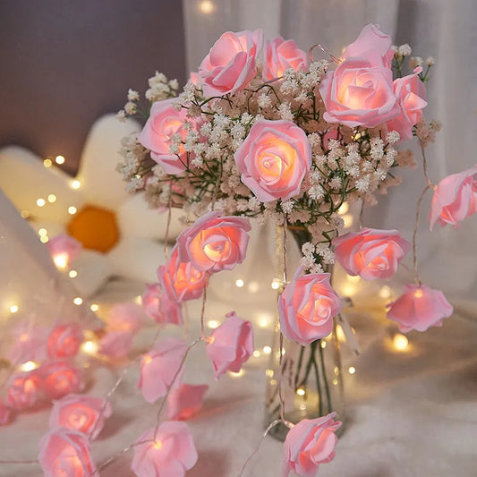 Vintage-style pink velvet rose fairy lights glowing softly around a glass vase with baby's breath flowers on a cozy table,.