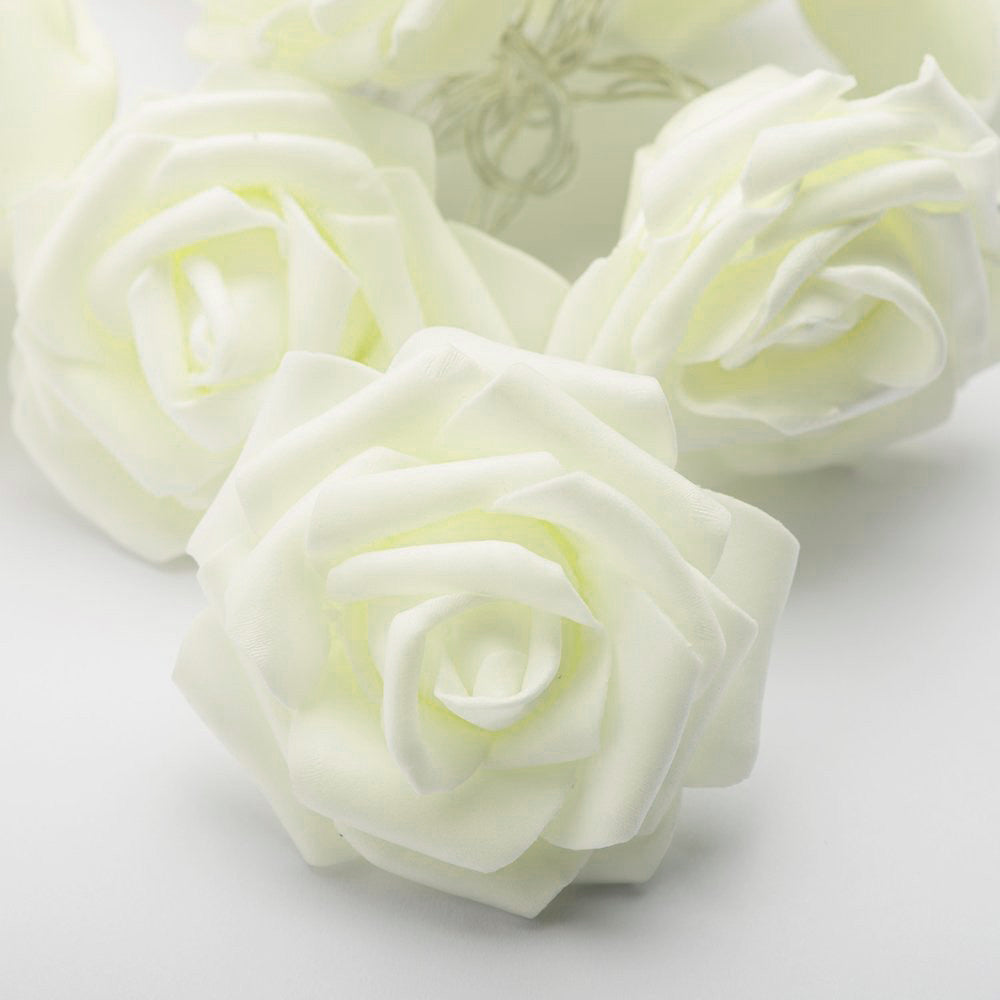 Close-up of soft white velvet rose 3D fairy lights with delicate petals, perfect for vintage-inspired home decor and.