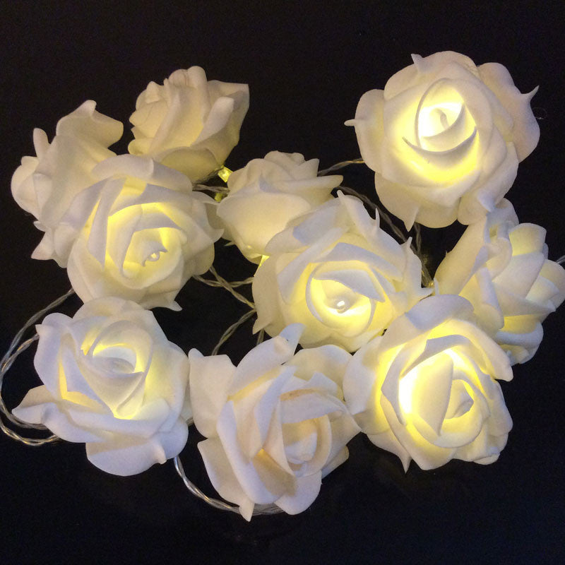 Warm white 3D white rose fairy lights with soft glowing petals, vintage-inspired velvet texture, perfect for retro home.
